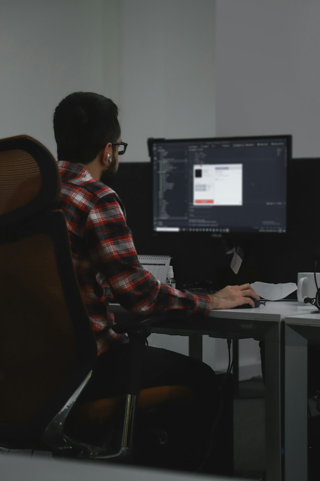person coding at desk