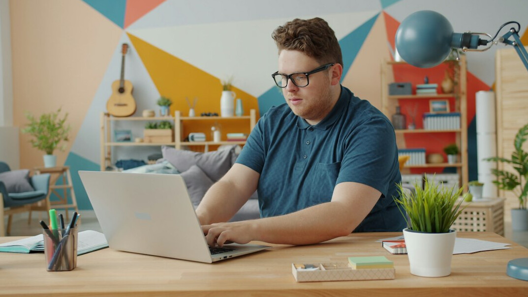 young person coding on laptop